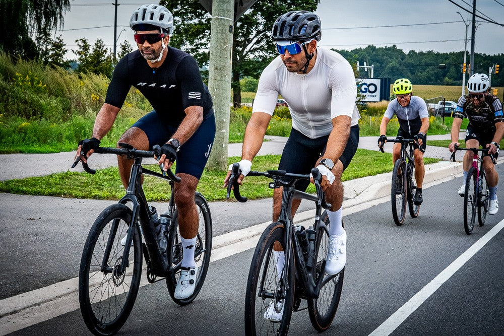 Two riders leading a group ride on Aquila bikes