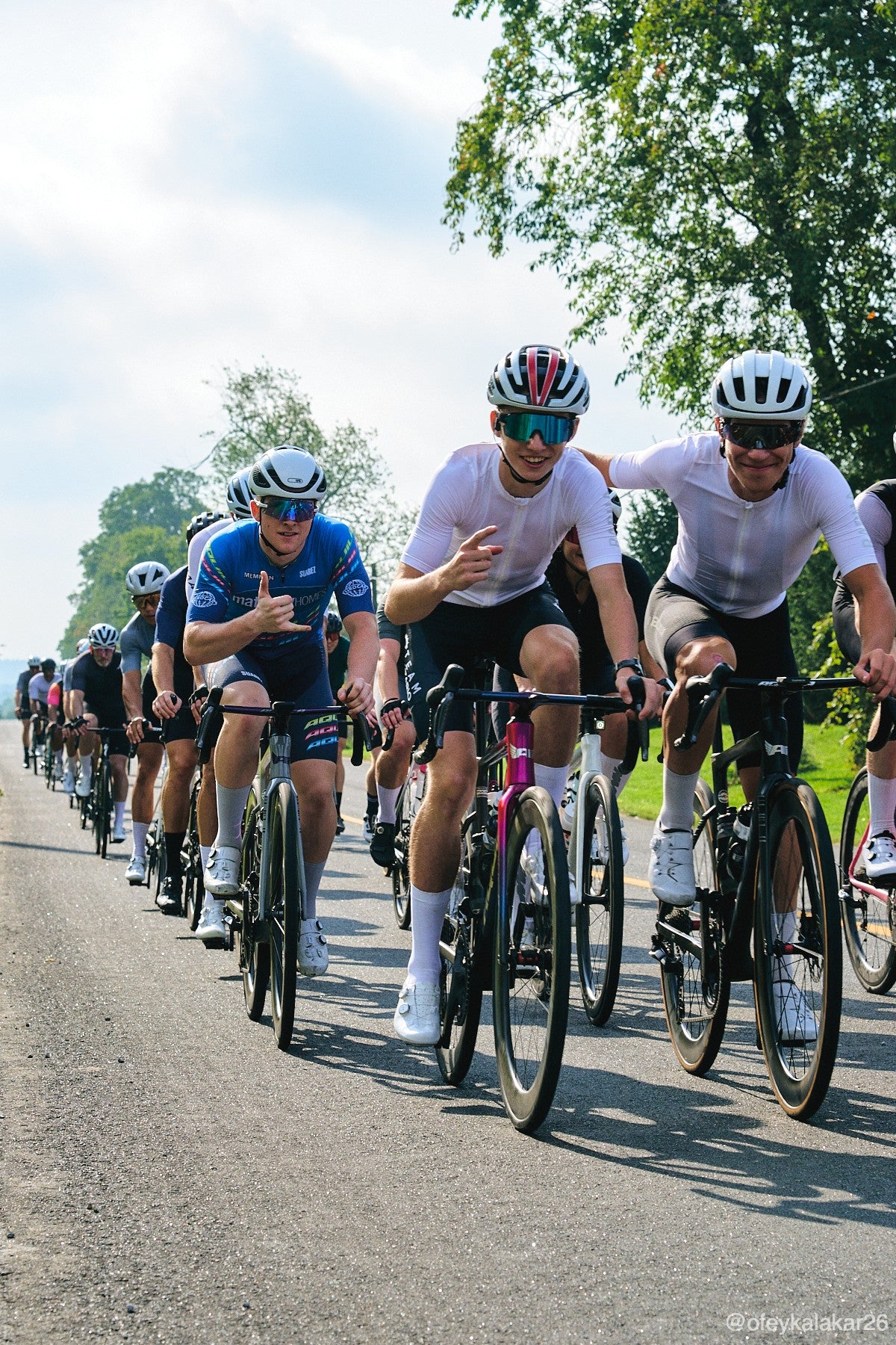 Riders on a group ride grinning at the camera