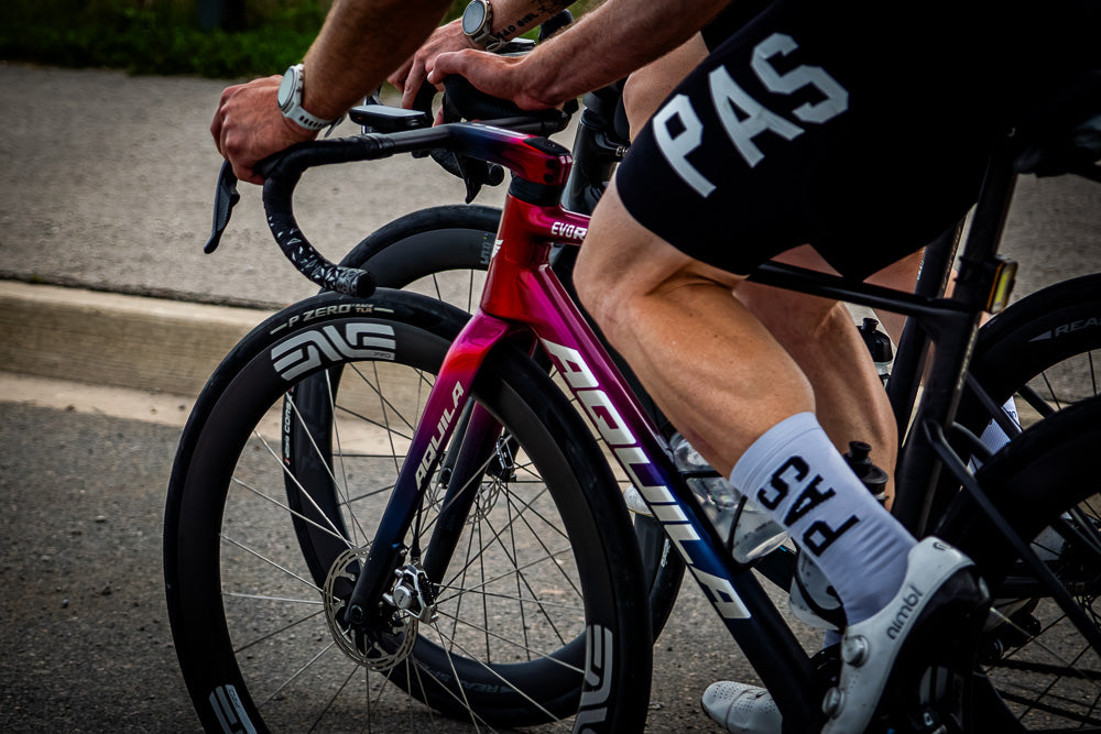 Hands on the bars of a pink Aquila EVO R